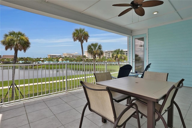 view of patio / terrace featuring ceiling fan, a balcony, and a water view