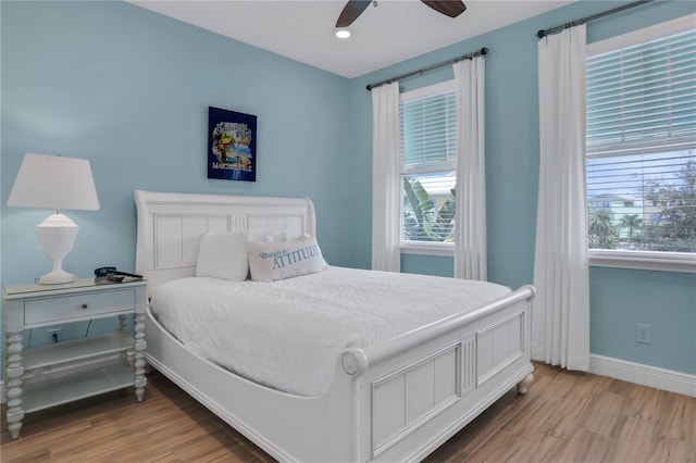 bedroom with ceiling fan and hardwood / wood-style flooring