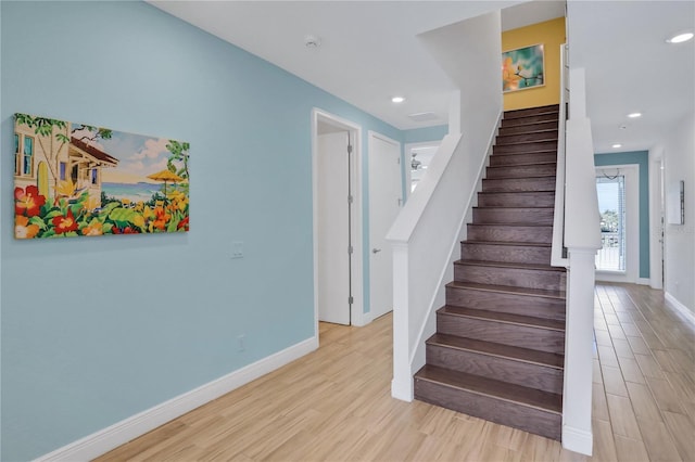 stairs with hardwood / wood-style flooring