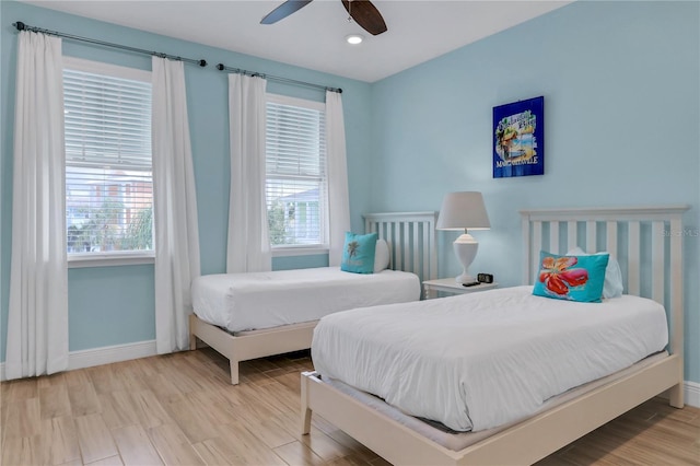 bedroom with ceiling fan and light hardwood / wood-style floors