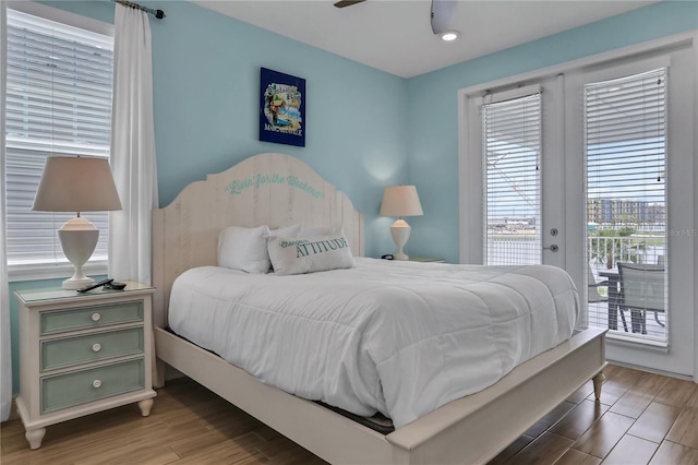 bedroom with ceiling fan, french doors, access to outside, and multiple windows