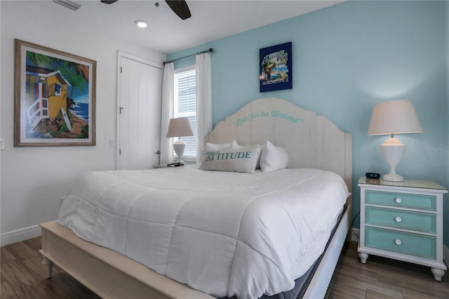 bedroom featuring ceiling fan, a closet, and dark wood-type flooring