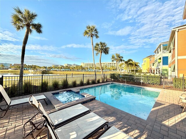 view of swimming pool featuring a patio and an in ground hot tub