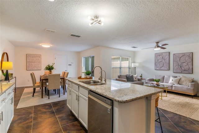 kitchen with sink, white cabinetry, light stone countertops, an island with sink, and stainless steel dishwasher