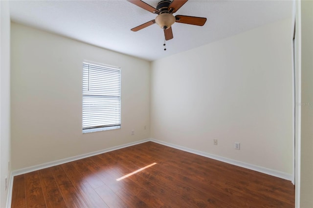 unfurnished room featuring dark wood-type flooring and ceiling fan