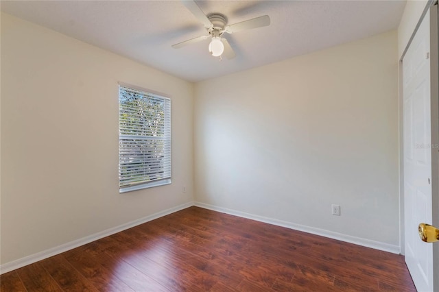 empty room featuring ceiling fan and dark hardwood / wood-style floors