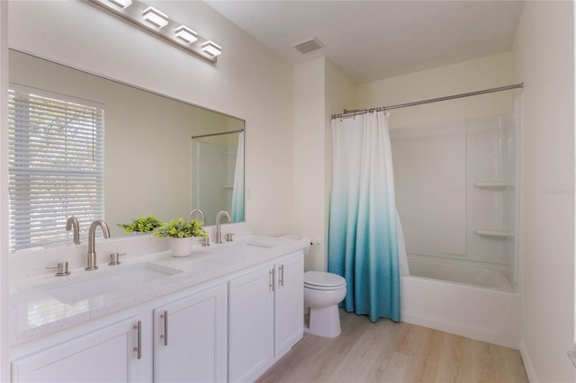 full bathroom featuring shower / bathtub combination with curtain, vanity, wood-type flooring, and toilet