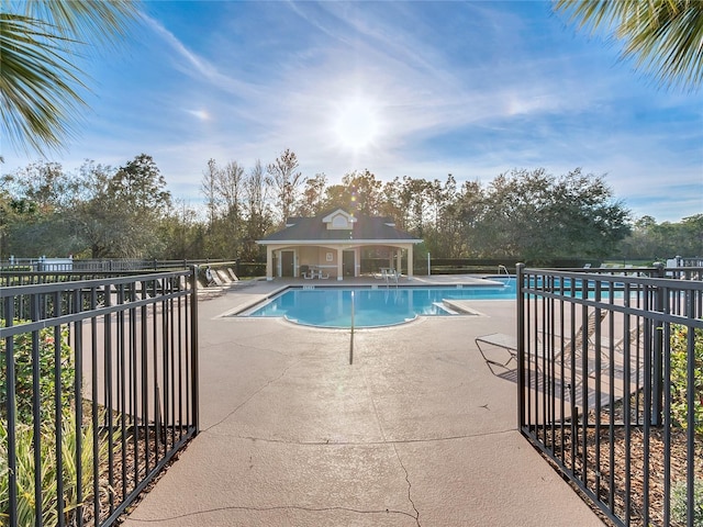 view of pool with an outbuilding and a patio area