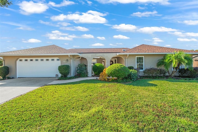 view of front of property featuring a front yard and a garage