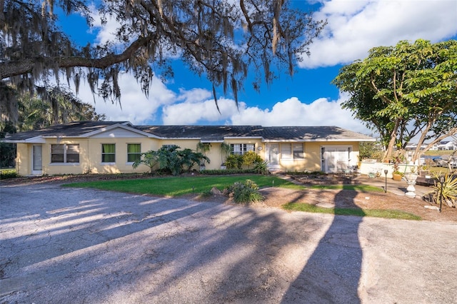 ranch-style home with a front lawn