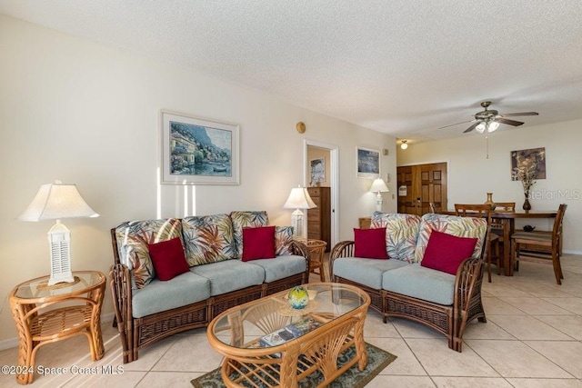 tiled living room with ceiling fan and a textured ceiling