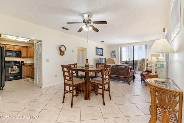 dining room featuring light tile patterned floors, a textured ceiling, and ceiling fan