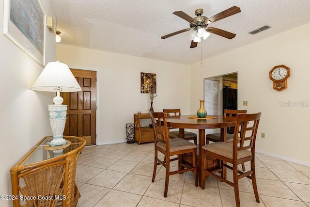 dining area with light tile patterned floors, a textured ceiling, and ceiling fan