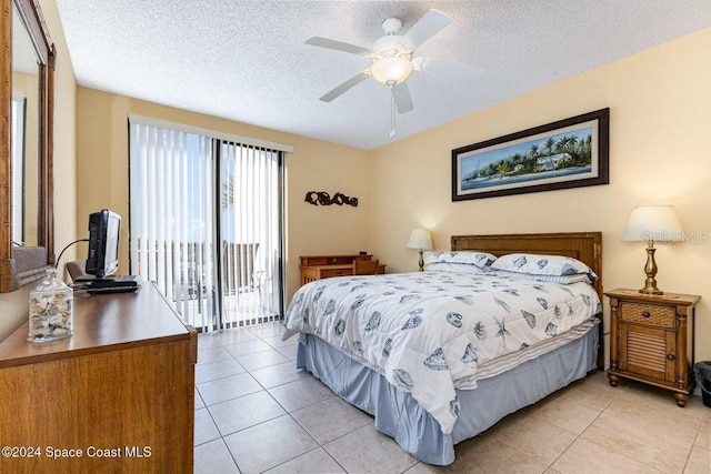 bedroom with ceiling fan, light tile patterned floors, a textured ceiling, and access to outside