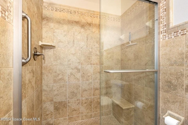 bathroom with a shower with shower door