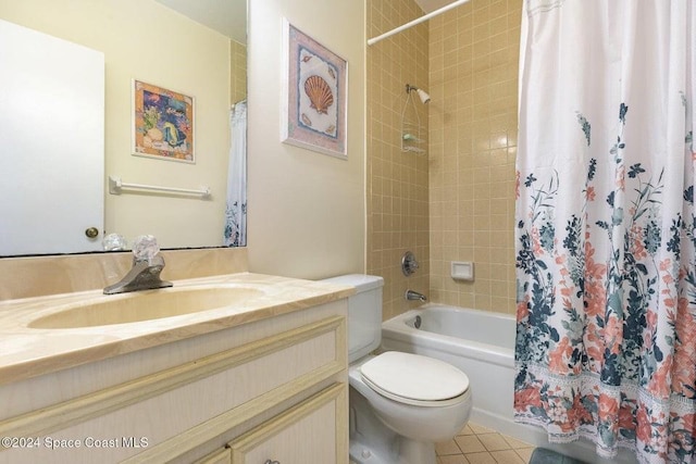 full bathroom featuring tile patterned floors, vanity, toilet, and shower / tub combo with curtain