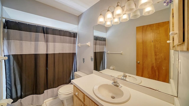 bathroom with toilet, vanity, tile patterned flooring, and a textured ceiling