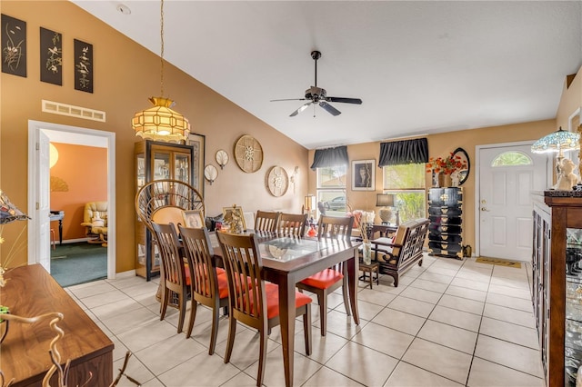 tiled dining area featuring ceiling fan and lofted ceiling