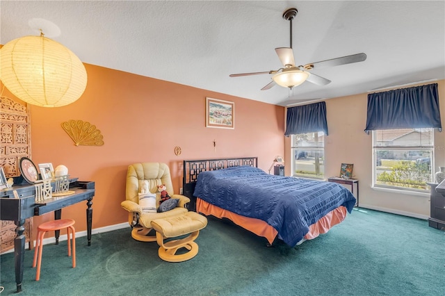 carpeted bedroom with a textured ceiling and ceiling fan