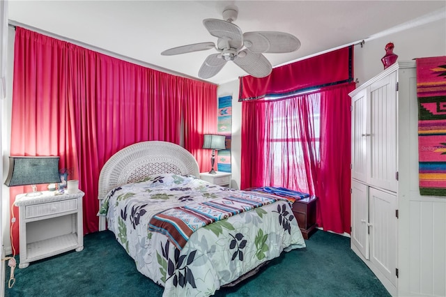 bedroom with ceiling fan and dark carpet