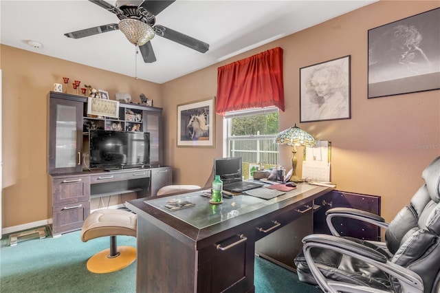 carpeted office space with ceiling fan