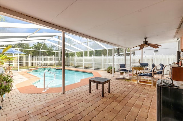 view of pool featuring a lanai, a patio area, and ceiling fan