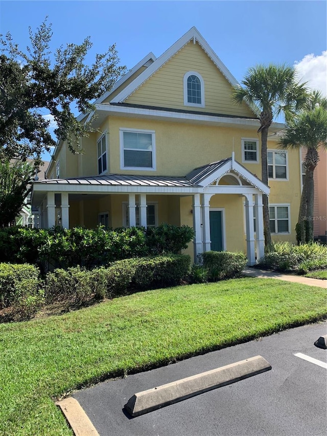 view of front of property featuring a front lawn and stucco siding