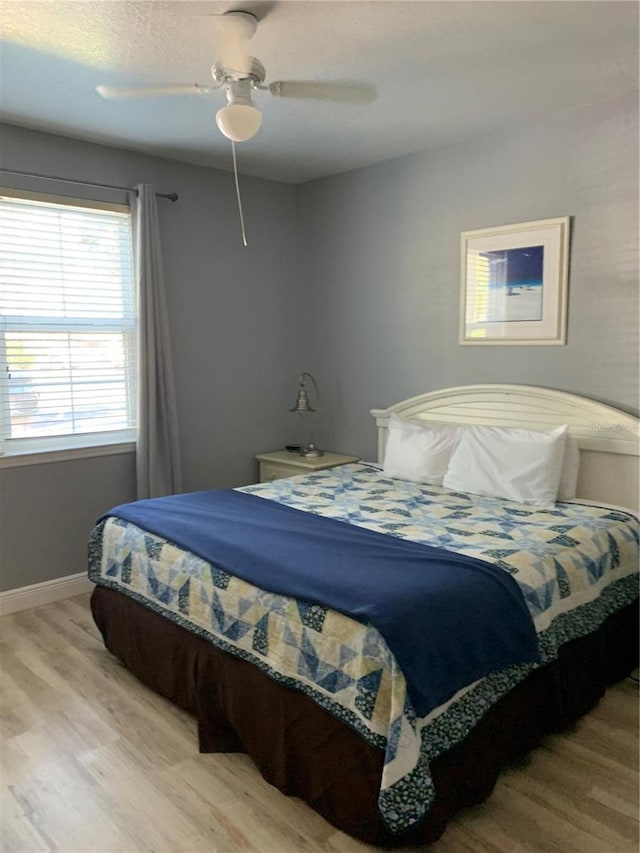 bedroom featuring ceiling fan and light wood-type flooring