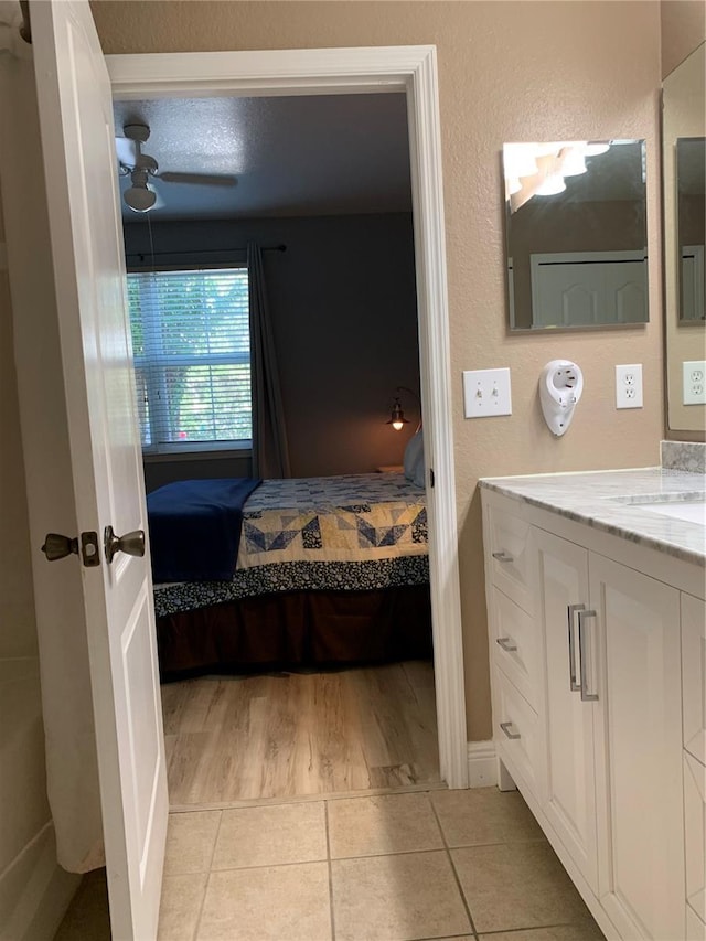 bathroom featuring vanity, tile patterned floors, and ceiling fan