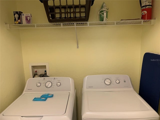 laundry area with washing machine and clothes dryer