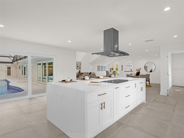 kitchen featuring island exhaust hood, a center island, white cabinets, and black electric cooktop