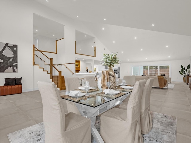 dining room with high vaulted ceiling