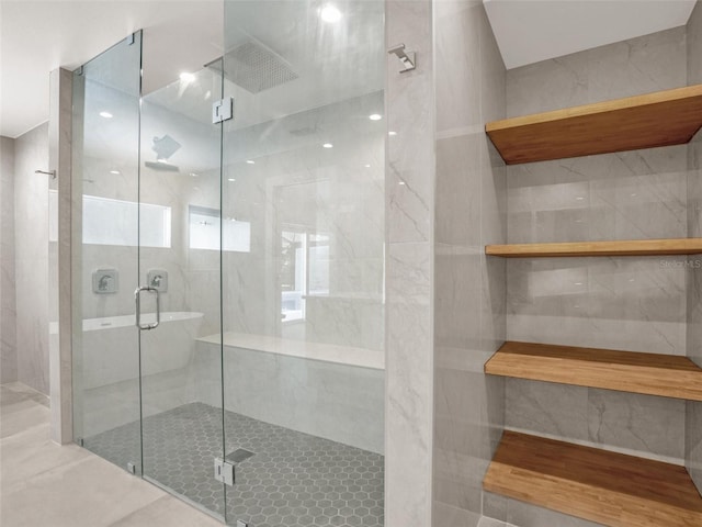 bathroom featuring a shower with door