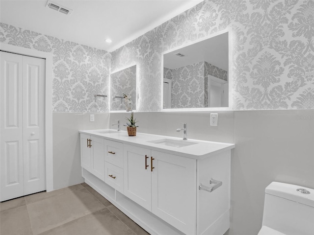 bathroom with tile patterned floors, vanity, and toilet