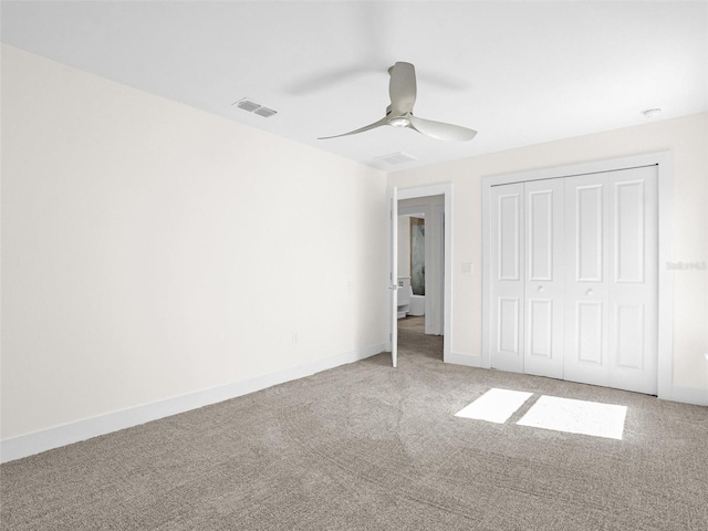 unfurnished bedroom with ceiling fan, a closet, and carpet floors