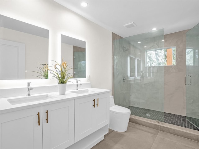 bathroom with vanity, toilet, and a shower with door