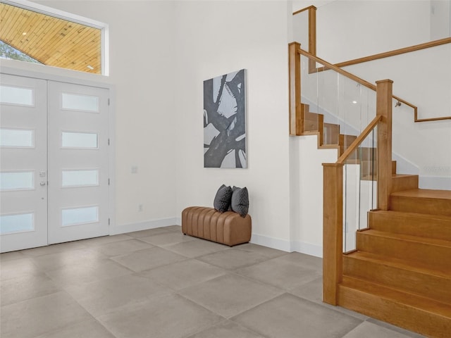 foyer entrance featuring french doors and a towering ceiling