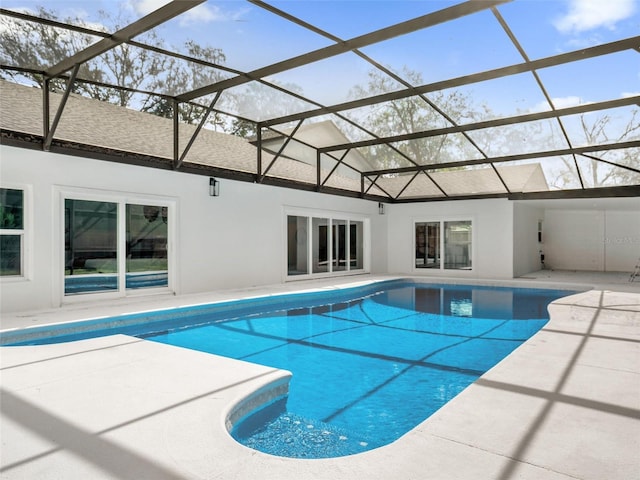 view of pool with a mountain view, a patio area, and a lanai