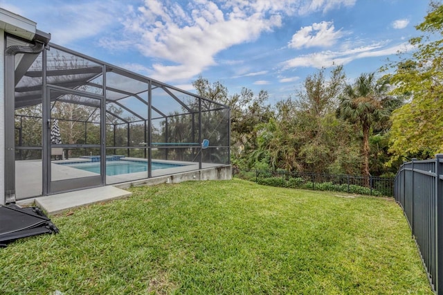 view of yard with a lanai, a fenced backyard, and a fenced in pool