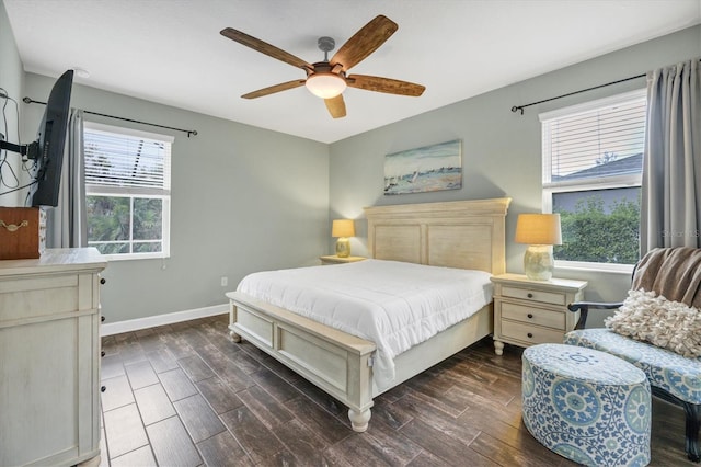 bedroom featuring a ceiling fan, baseboards, and wood finished floors