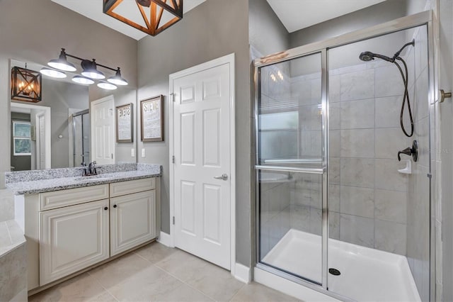 bathroom featuring tile patterned floors, a shower stall, and vanity