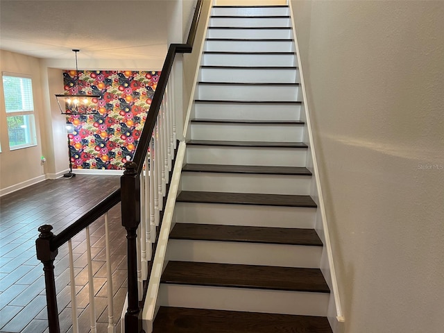 stairway featuring wood finished floors and baseboards