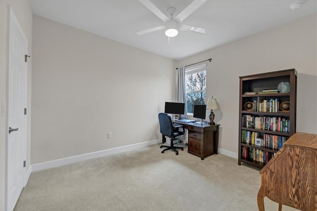 home office featuring carpet floors, a ceiling fan, and baseboards