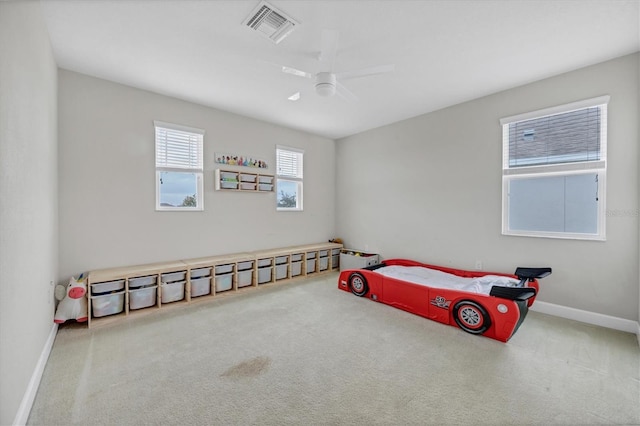 carpeted bedroom with baseboards, visible vents, and ceiling fan