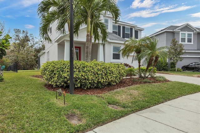 view of property exterior featuring a garage, concrete driveway, a lawn, and stucco siding