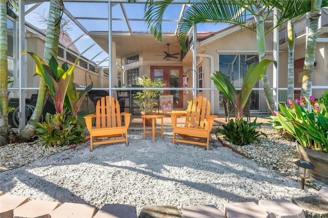 view of patio featuring ceiling fan and a lanai