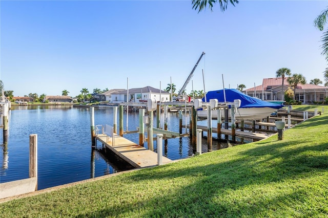 dock area featuring a lawn and a water view