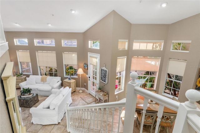 living room featuring a healthy amount of sunlight and a high ceiling