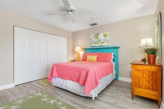 bedroom featuring ceiling fan, light hardwood / wood-style floors, and a closet