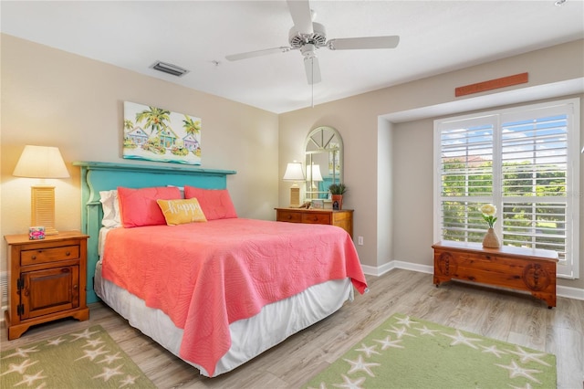 bedroom with ceiling fan and hardwood / wood-style flooring